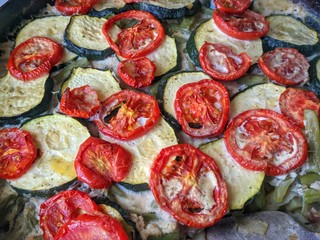 casserole with vegetables. zucchini, tomatoes, eggs, meat. in the pan.