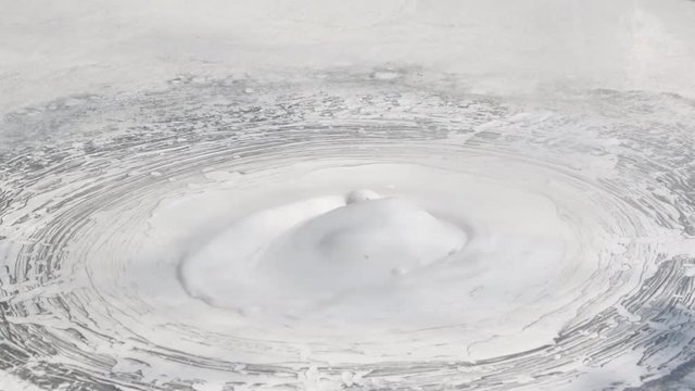 closeup of gray mud boiling bubble hell hot springs at Japan.