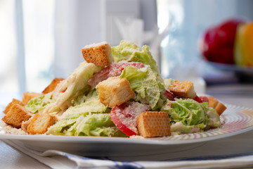 Fresh vegetable salad with crackers on a table in a cafe