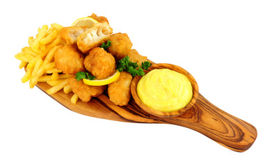 Battered cod nugget bites with potato French Fries and mayonnaise dip on an olive wood serving board isolated on a white background