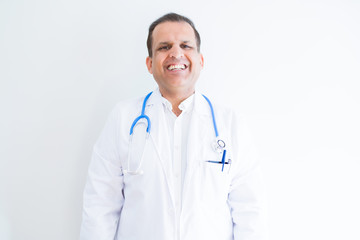Fototapeta premium Middle age doctor man wearing stethoscope and medical coat over white background with a happy and cool smile on face. Lucky person.