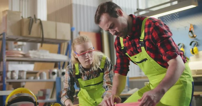 Carpenter with apprentice in training period