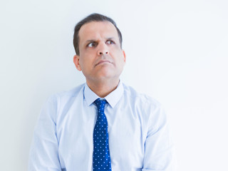 Middle age man thinking clueless about a question