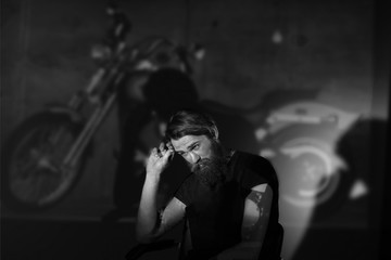 portrait of a serious man biker in a black t-shirt.