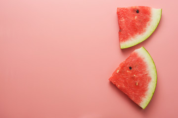 Watermelon slices on pink background. Summer foods. Copy space. Isolated.