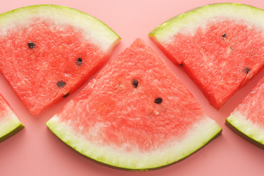 Slices of watermelon isolated on pink background. Top view. Flat lay. Summer background.
