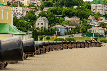 Replica cannons from battleship Goto Pristancia on Admiralteyskaya Square on clear sunny day. Behind  cannons located Assumption Admiralty temple. Voronezh, Russia, June, 2019. 