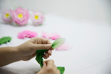 Woman making beautiful nylon flower - people with DIY handmade flower concept