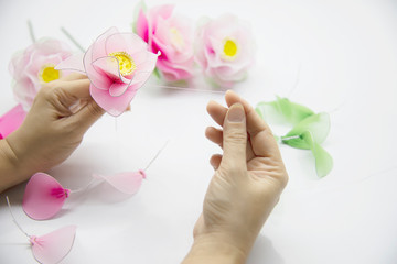 Woman making beautiful nylon flower - people with DIY handmade flower concept