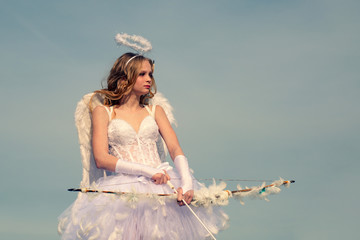 Real fairy from magical stories. Concept of innocent child. A beautiful teen with blonde curly hair...