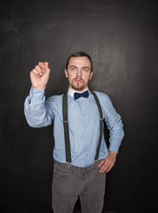 Handsome business man touch something on blackboard