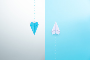 Blue and white paper planes flying in different directions. dissenting opinion, divergent views...