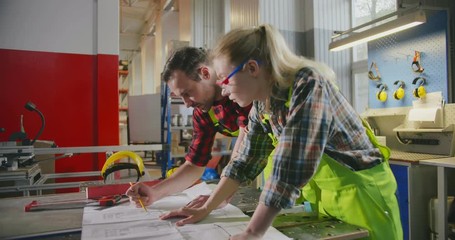 Carpenters studying blueprint