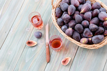 Figs in a basket and glasses of wine