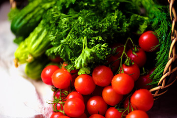 Cherry tomatoes and greens in a basket