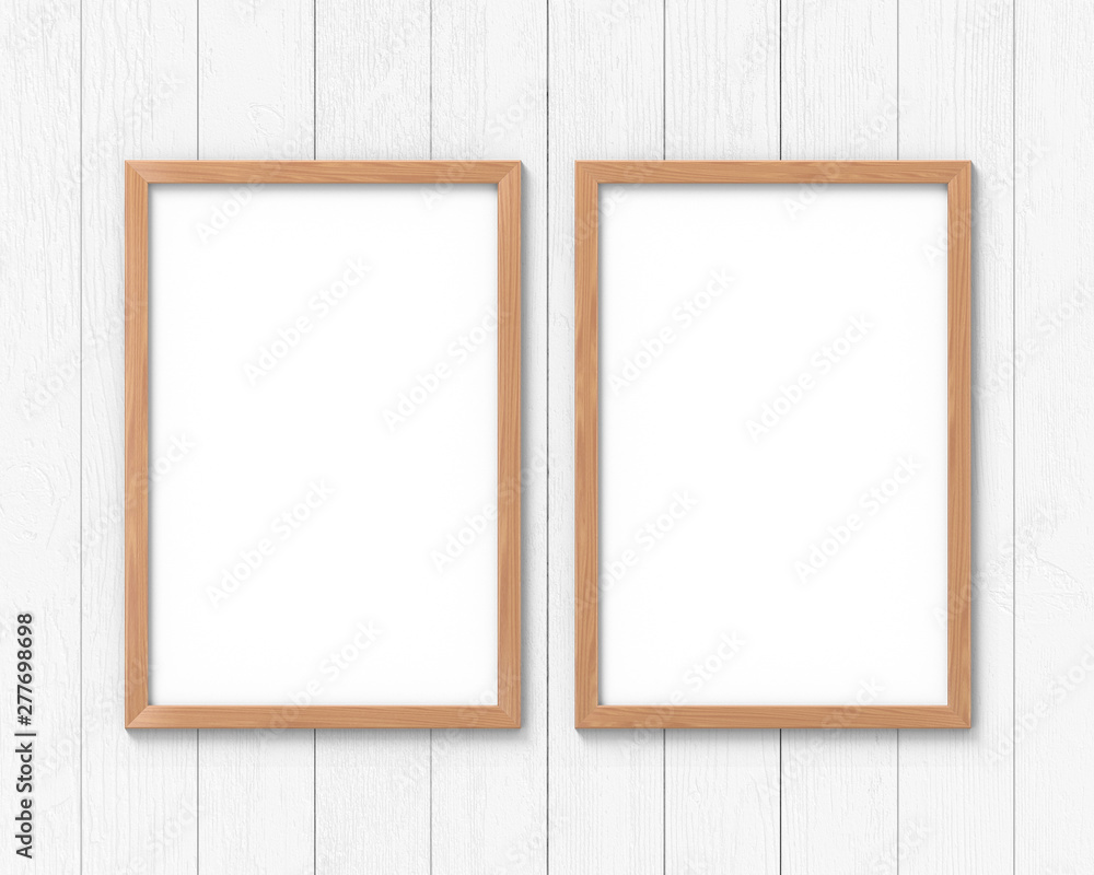 Poster set of 2 vertical wooden frames mockup with a border hanging on the wall. empty base for picture or 