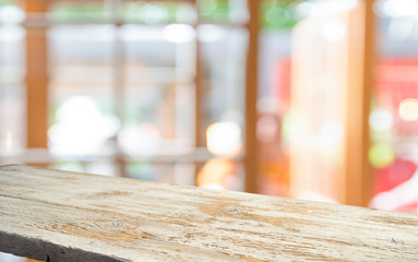 Empty of wood table top on blur of curtain with window view green from tree garden background.For...