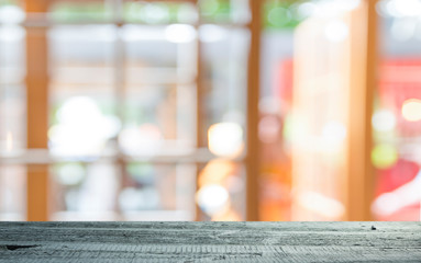 Empty of wood table top on blur of curtain with window view green from tree garden background.For montage product display or design key visual layout