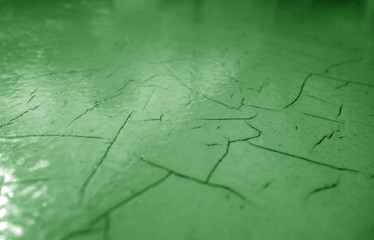 Cracked paint texture in green color.