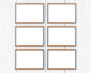 Set of 6 horizontal wooden frames mockup hanging on the wall. Empty base for picture or text. 3D rendering.