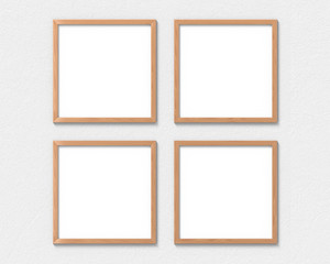 Set of 4 square wooden frames mockup hanging on the wall. Empty base for picture or text. 3D rendering.