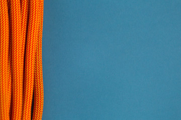 Orange rope for climbing on a blue background.