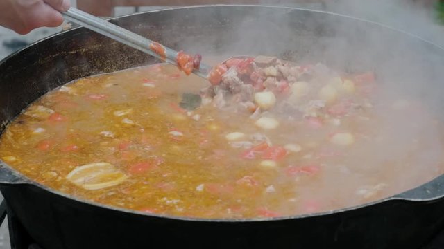 Bograch. Soup with paprika, meat, bean, vegetable, dumpling. Traditional Hungarian Goulash in cauldron. Meal cooked outdoors on an open fire. Delicious and healthy food popular in Central Europe