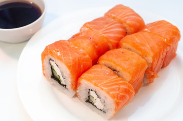 Rolls with salmon soy sauce on a plate
