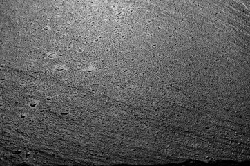 Wet slate stone dark background top view