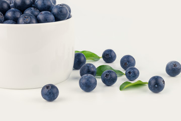 close up blueberry beside ceramicon bowl