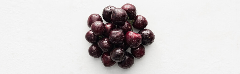 panoramic shot of fresh, sweet, red and ripe cherries with water drops