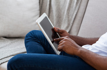 African-american man using digital tablet at home