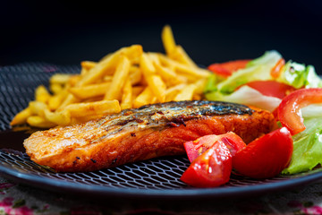Grilled Salmon with fresh lettuce and Golden French fries