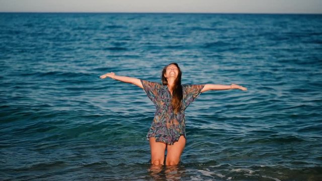 young woman falls into the sea backward slowmotion