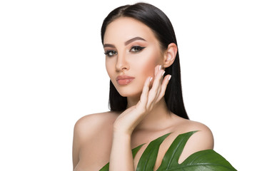 tanned woman face with perfect makeup and healthy skin with tropical leaf isolated on white....
