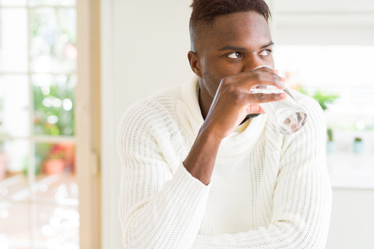 Young african american man drinking a fresh glass of water