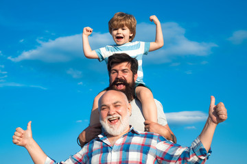 Fathers day concept. Happy three generations of men have fun and smiling on blue sky background....