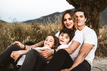 Fototapeta premium Portrait of a happy and funny young family outdoors