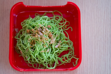 Jade noodle on red tray