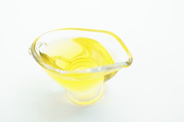 Obraz na płótnie Canvas Top view of glass with olive oil on white background