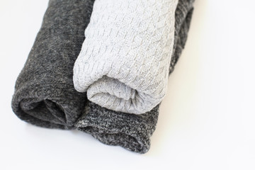 Three knitted gray woolen gray fabrics with different knitting on a white isolated background with free space