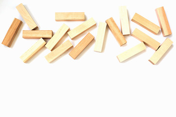 scattering of wooden bars in the upper part of the frame on a white isolated background with free space below