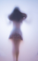Blurred silhouette of a jumping girl