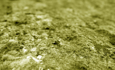 Old stone surface with blur effect in yellow tone.