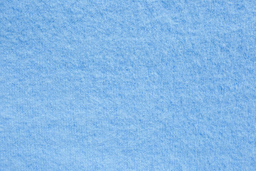 Background texture of blue pattern knitted fabric made of cotton or wool. close up
