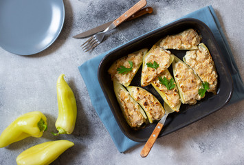 Roasted peppers stuffed with cheese and herbs in baking tray. Healthy Meatless Meal. Characteristic dish of the Balkan cuisine. Serbian cuisine. Gray background, top view, copy space