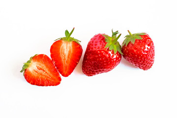 Whole and cut strawberry berries closeup isolate