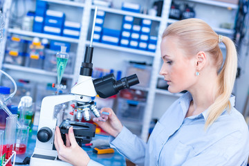 Laboratory assistant uses a polarizing microscope in a microbiological laboratory