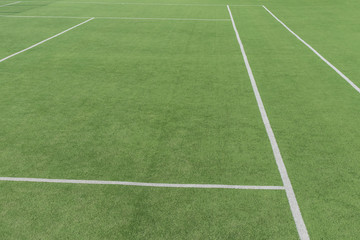 Fototapeta na wymiar Part of the tennis court with markup. Artificial surface green sports field.