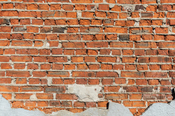 Red brick stone wall. Old red brick wall. Brick wall with concrete elements. Textures brick wall.